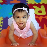 baby girl climbing slide