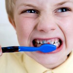 Boy hating to brush his teeth