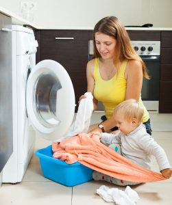 Mom doing laundry with kids