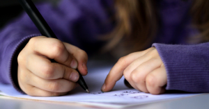 kid writing in journal